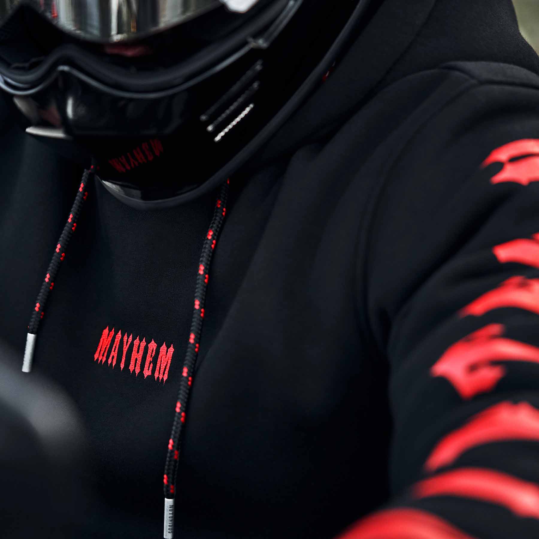 close up von einem schwarzen crewneck aus der notorious thirteen kollektion - stick als nahaufnahme in rot